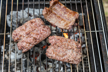Sausages cook on the grill