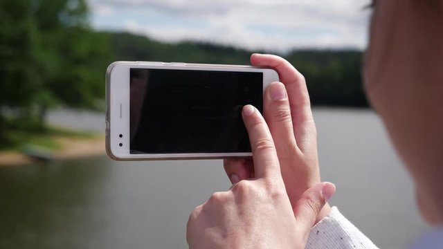 Take pictures via white mobile smartphone of a nature view