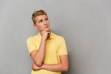 Portrait of a pensive casual teenage boy looking away