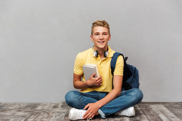 Portrait of a smiling casual teenage boy with backpack