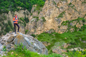 Fototapeta na wymiar Girl with a backpack in the mountains.