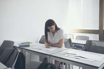 A Girl Sitting at Classroom