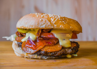 Delicious and juicy burger with appetizing meatball and fresh vegetables