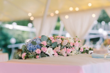 Elegant composition from fresh flowers on a wedding table