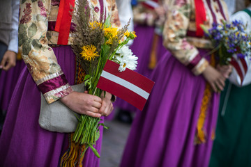 Fototapeta na wymiar Song and dance festival in Latvia. Procession in Riga. Elements of ornaments and flowers. Latvia 100 years.