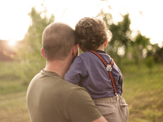 Fototapeta premium son in the hands of his father