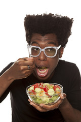 young handsome afro american guy eat salad isolated on white background. healthy food concept