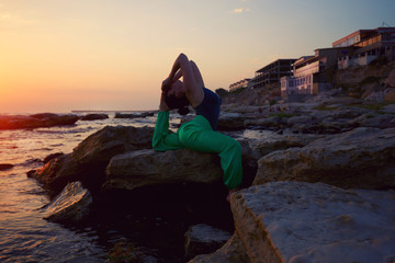 Meditation, serenity and yoga practicing at sunset.Silhouette meditation girl on the background of the stunning sea and sunset.  yoga poses fitness. Calm and self-control. copy space for advertising