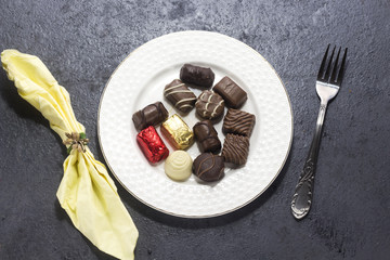  various chocolate on white plate for valentine's day, love chocolate concept