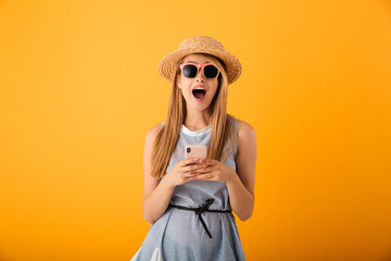 Portrait of an excited young blonde woman in summer hat