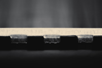 Detailed background of fragment of automotive radiator in macro with copy space. Monochrome image of metallic auto part is close-up. Empty surface of steel texture.