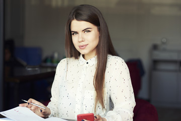 Woman typing write message on smart phone in a modern cafe cropped image of young pretty girl....