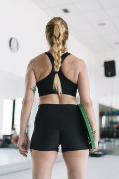 back view Woman exercising with disc