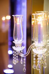 The crystal candle holder with candles in white.