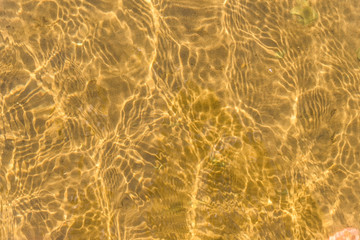 Yellow sandy bottom under the crystal clear water, the concept of eco-friendly holiday