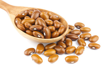 Haricot beans in a wooden spoon  isolated on white background