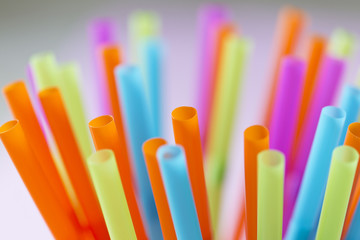 Colorful straws on a pink background