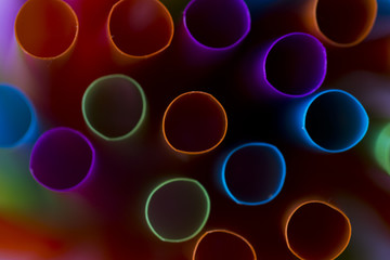 Colorful straws on a pink background