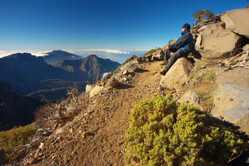 Resting man watching a landscape above the crater Caldera de Taburiente, Island of La Palma, Canary Islands, Spain