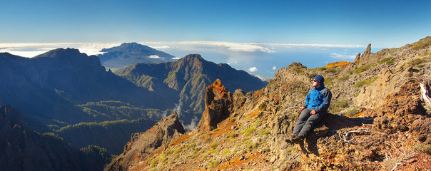 Resting man watching a landscape above the crater Caldera de Taburiente, Island of La Palma, Canary Islands, Spain