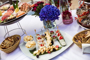 Cheese with pear and strawberries lie on plate
