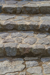 Steps of a street staircase made of natural stone