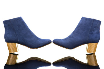 A pair of blue shoes facing each other isolated on a white background with a reflection