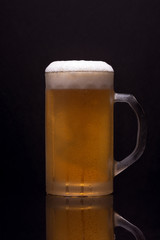 Cold mug with blonde beer