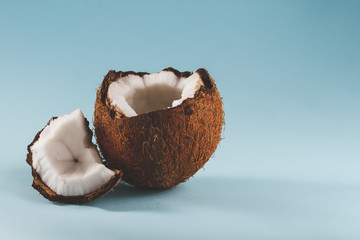 The cut coconut lies on a blue background.