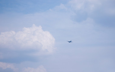 A plane is flying high up in the sky.