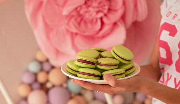 Happy  Woman  Holdind Pistachio Macaroons