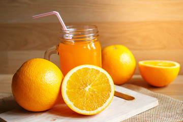 Orange and orange juice on wooden background