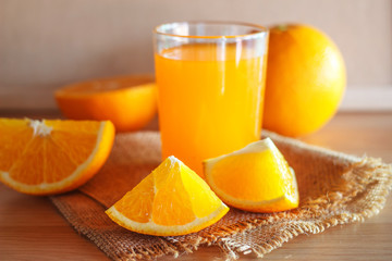 Orange and orange juice on wooden background
