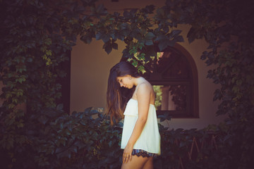 beautiful teenage girl relaxed in a window with Ivy