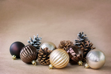Photo of New Year's toys and cones on a beige background with a vignette