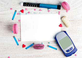 Frame for text from Sweet macaroons, insulin pen, glucometer, blood sugar check strips, chocolate...