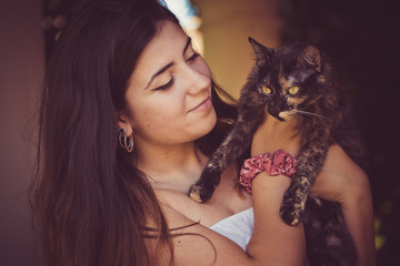 beautiful teenage girl playing with dark cat