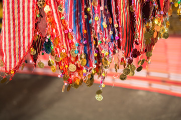 Fake gold coins are on the scarf edges