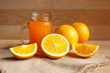 Orange and orange juice on wooden background