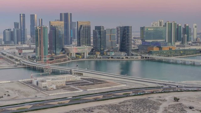 Aerial skyline of Abu Dhabi city centre from above day to night timelapse