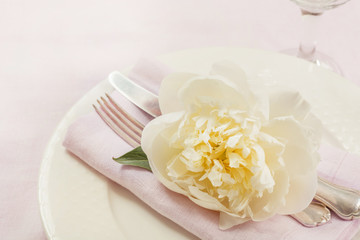 Romantic dinner. Table setting on pink linen tablecloth. Top view.