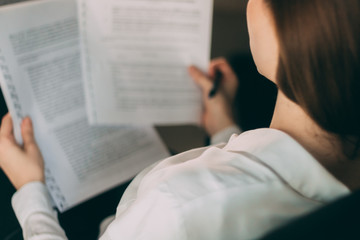 Close up of businesswoman reading documents.