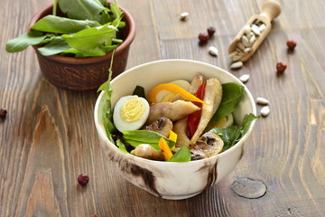 Chicken and mushroom salad with quail eggs and fresh herbs