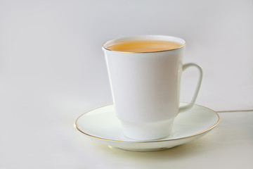 porcelainl cup with green tea on table