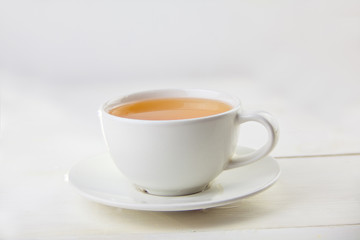 porcelainl cup with green tea on table
