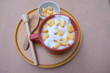 A cup of hot milk with biscuit
