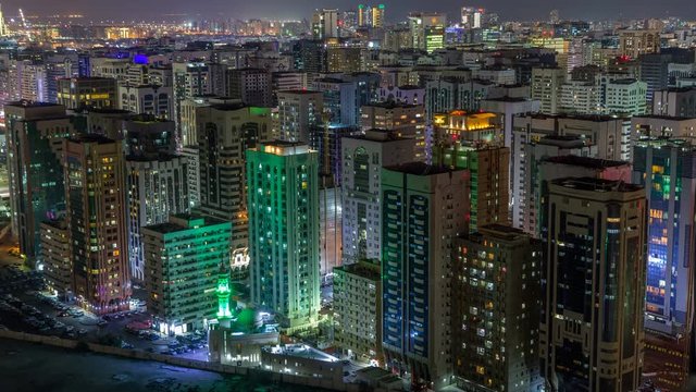 Aerial skyline of Abu Dhabi city centre from above night timelapse