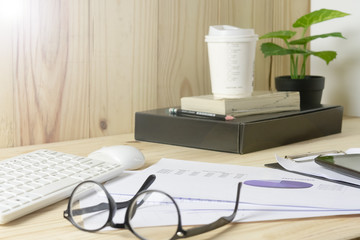 Close up business document and glasses with laptop and pencil coffee cup etc,Or document business concept.