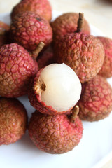 Fresh and juicy lychees on neutral background.