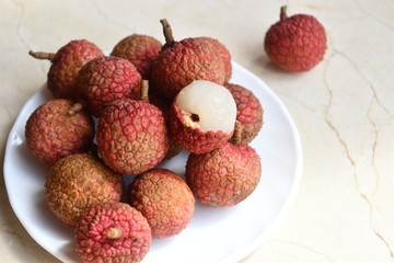 Fresh and juicy lychees on neutral background.